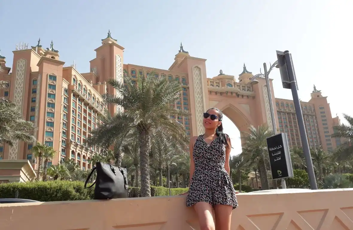 Girl Standing in front of high rise buildings in Dubai